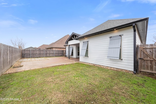 back of property with a patio area and a yard