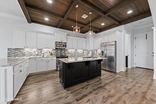 kitchen featuring hardwood / wood-style flooring, white cabinetry, and stainless steel appliances