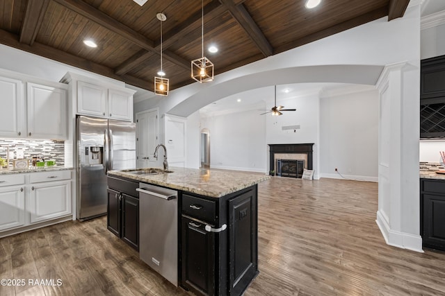 kitchen featuring wooden ceiling, appliances with stainless steel finishes, white cabinets, and sink