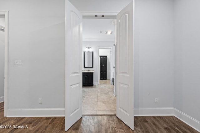 hall featuring light wood-type flooring and ornamental molding