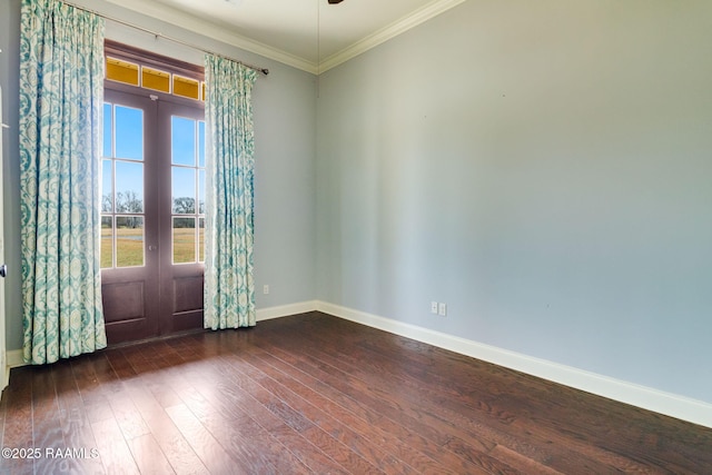 spare room featuring ornamental molding, dark wood-type flooring, and french doors