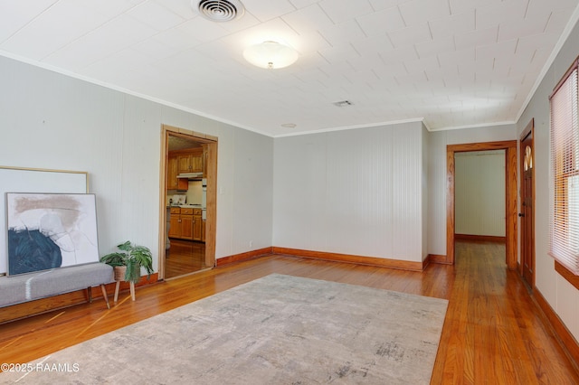 interior space featuring crown molding and wood-type flooring