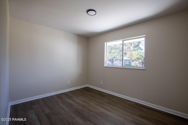 spare room featuring dark wood-type flooring