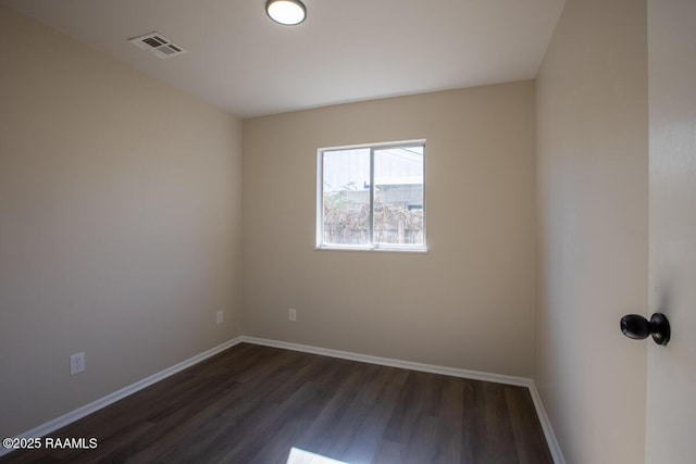 spare room with dark hardwood / wood-style floors