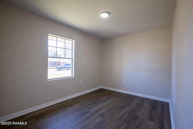 unfurnished room with dark hardwood / wood-style flooring