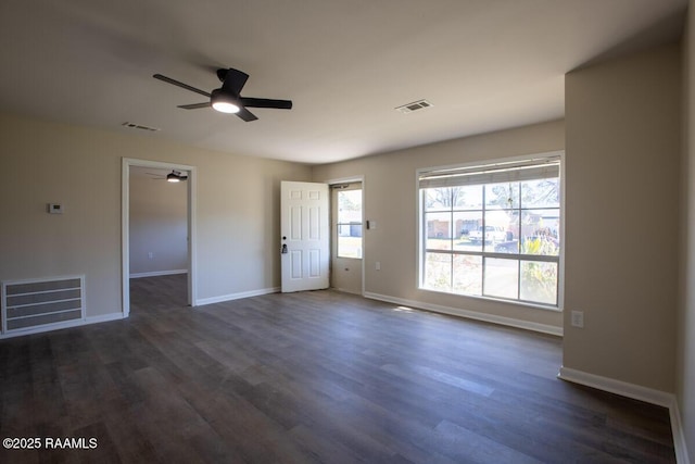 empty room with ceiling fan and dark wood-type flooring