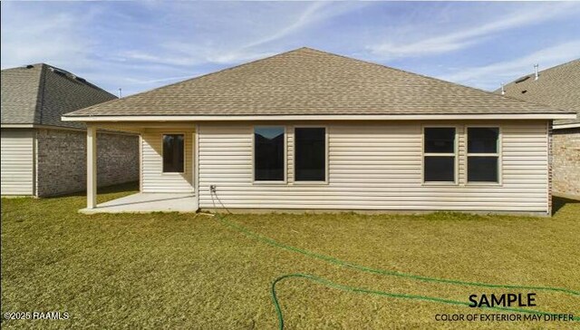 rear view of house featuring a patio area and a lawn