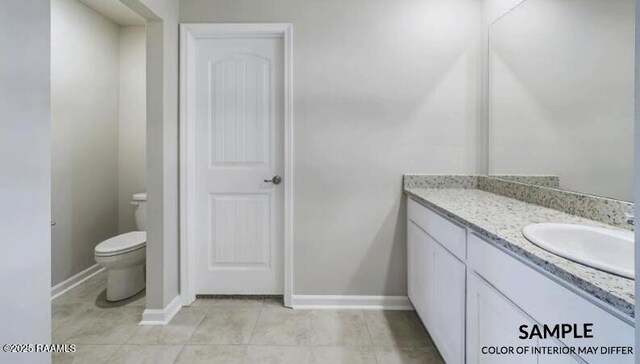 bathroom featuring toilet, tile patterned floors, and vanity