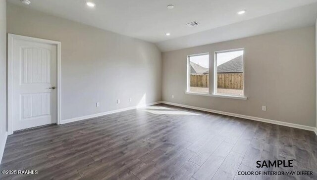 spare room with dark hardwood / wood-style floors and lofted ceiling