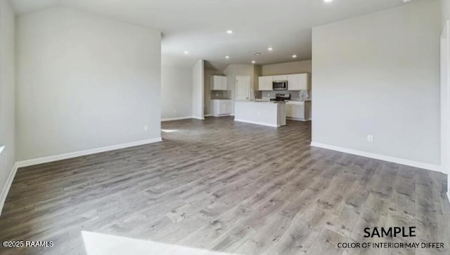 unfurnished living room with vaulted ceiling and light hardwood / wood-style flooring
