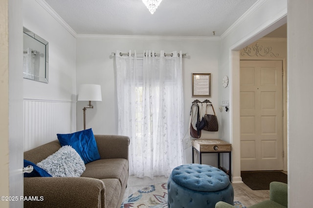 sitting room featuring ornamental molding and a textured ceiling