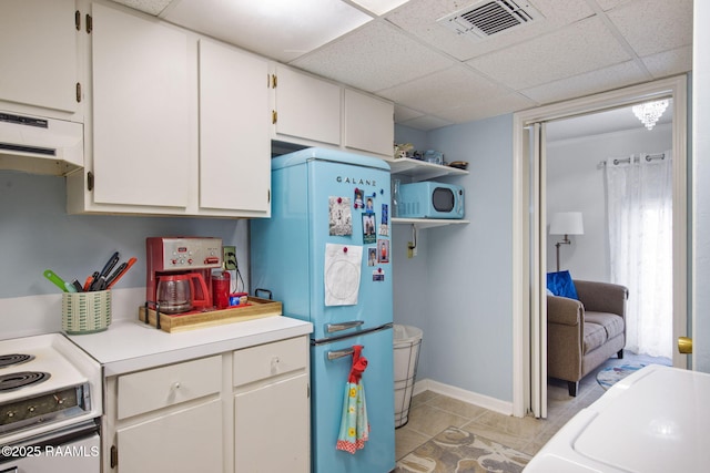 kitchen with a drop ceiling, refrigerator, washer / clothes dryer, white electric stove, and white cabinets