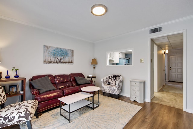 living room featuring dark wood-type flooring and crown molding