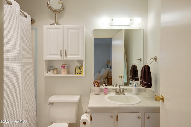 bathroom with toilet and vanity