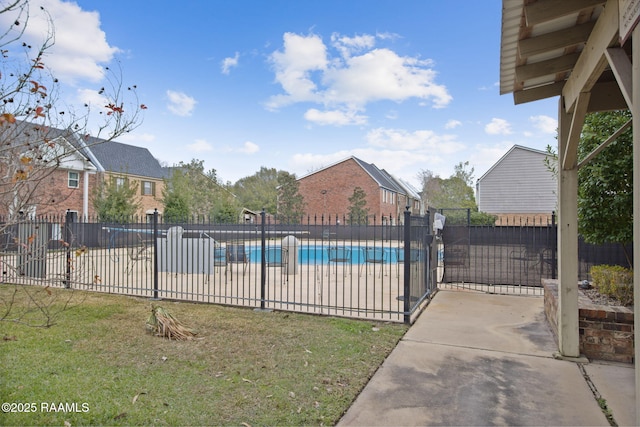 view of pool with a yard