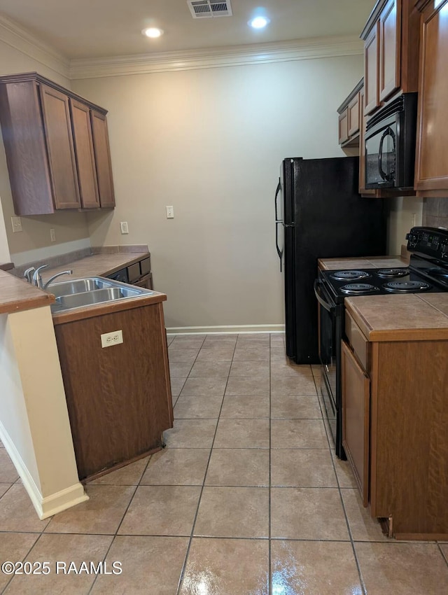 kitchen with black appliances, light tile patterned floors, sink, and ornamental molding