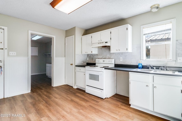 kitchen featuring white cabinetry, light hardwood / wood-style floors, electric range, a textured ceiling, and sink