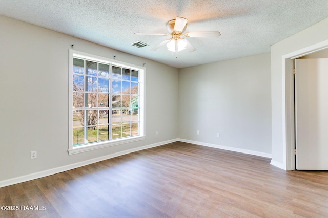 unfurnished room with light wood-type flooring, ceiling fan, and a textured ceiling