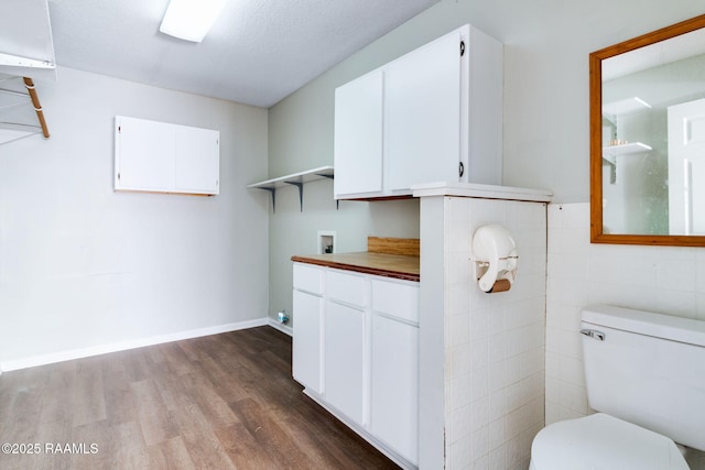 kitchen with white cabinetry and wood-type flooring