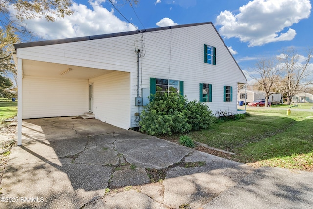 view of side of property with a yard and a carport