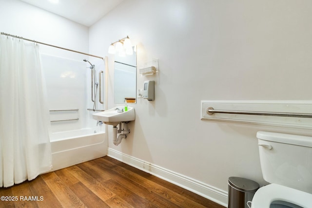 bathroom featuring toilet, shower / bath combination with curtain, and hardwood / wood-style floors