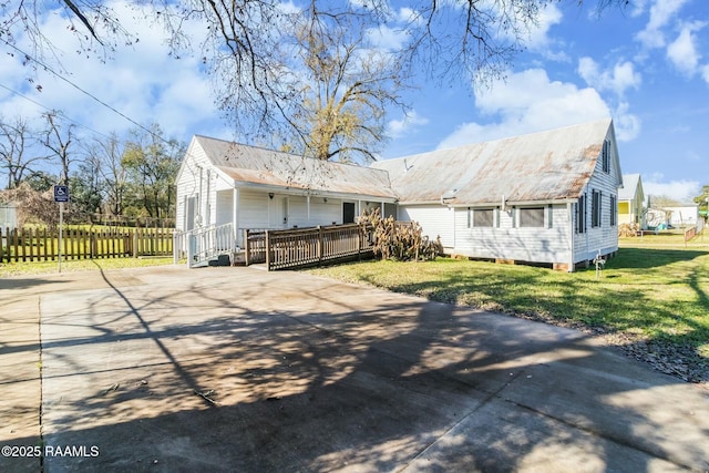 back of house featuring a deck and a yard