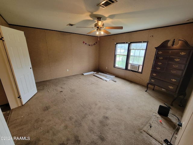 unfurnished bedroom featuring ceiling fan, light colored carpet, and cooling unit