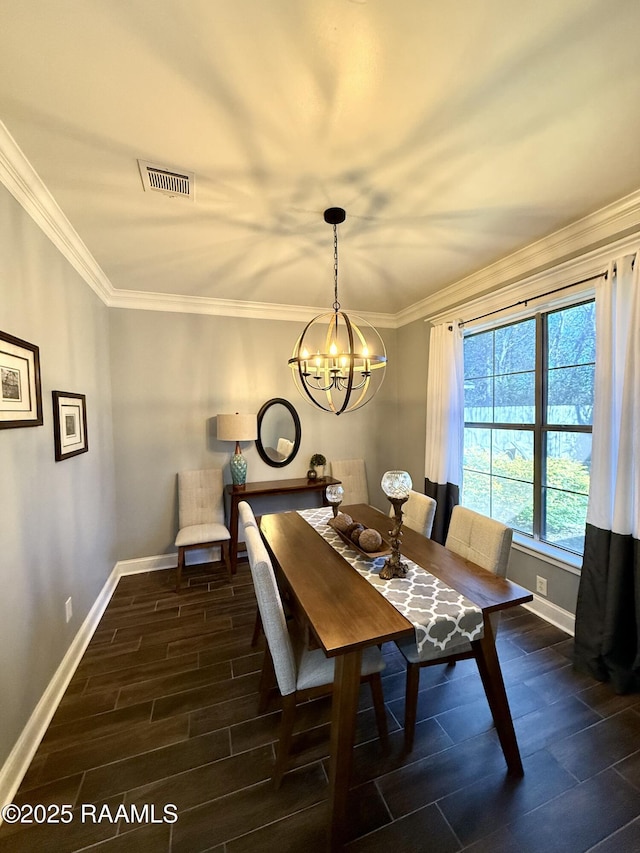 dining space featuring crown molding and an inviting chandelier