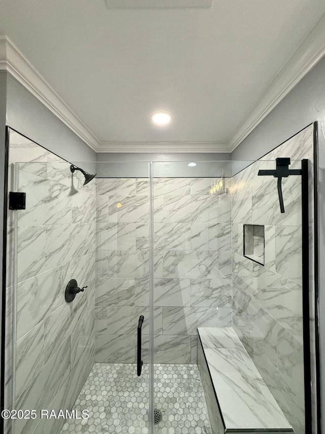 bathroom featuring crown molding and a shower with shower door