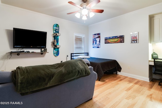 bedroom with ornamental molding, hardwood / wood-style floors, and ceiling fan