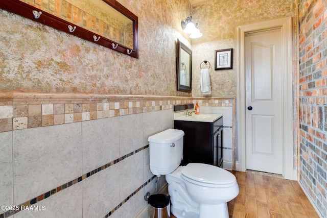 bathroom featuring vanity, toilet, and hardwood / wood-style floors