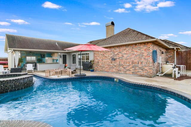 view of pool featuring a patio, exterior bar, and ceiling fan