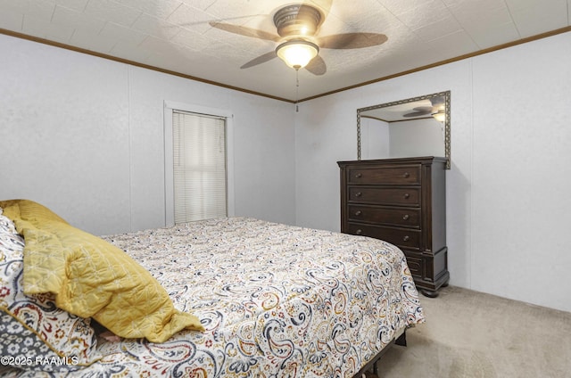 carpeted bedroom featuring ceiling fan and ornamental molding