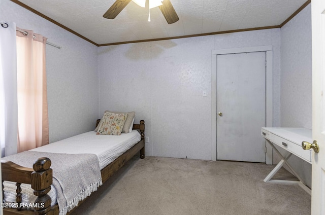 bedroom featuring ceiling fan, ornamental molding, a closet, and light colored carpet