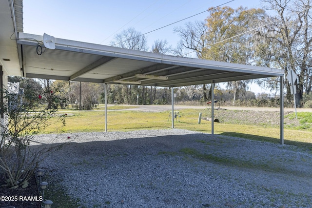 view of car parking featuring a yard and a carport