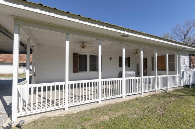 exterior space with ceiling fan and a lawn