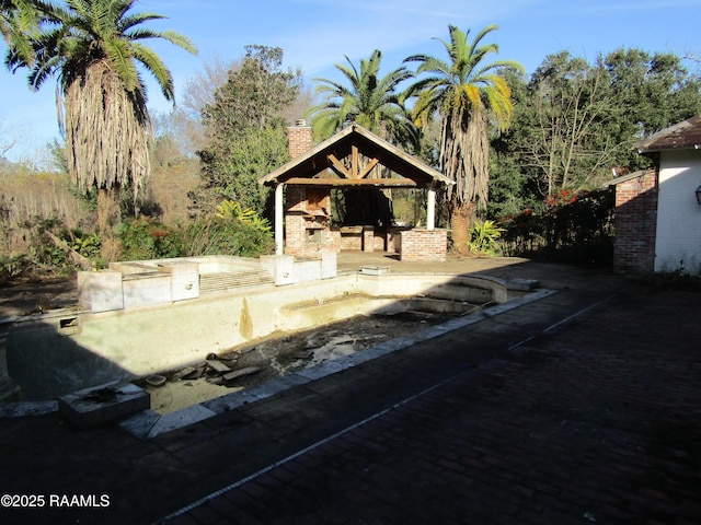 exterior space featuring a patio area, a gazebo, and an outdoor kitchen