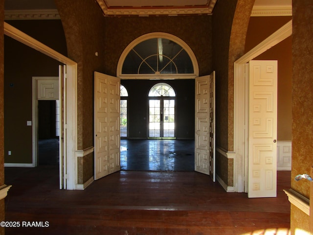 foyer with french doors, dark hardwood / wood-style flooring, and a high ceiling