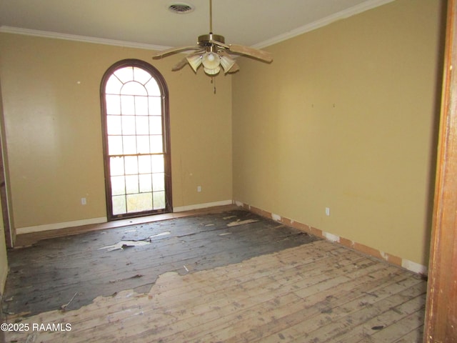 empty room with ceiling fan, wood-type flooring, and crown molding