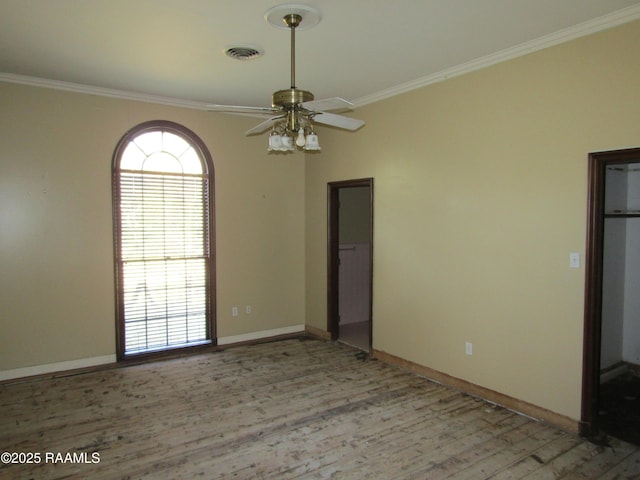 spare room featuring light wood-type flooring, ceiling fan, and ornamental molding