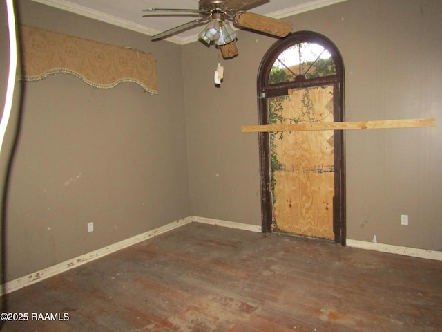 spare room with ceiling fan, dark hardwood / wood-style flooring, and crown molding