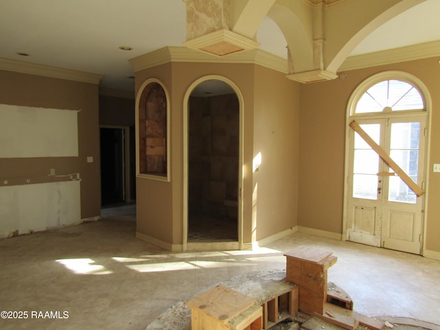 unfurnished room with french doors and crown molding