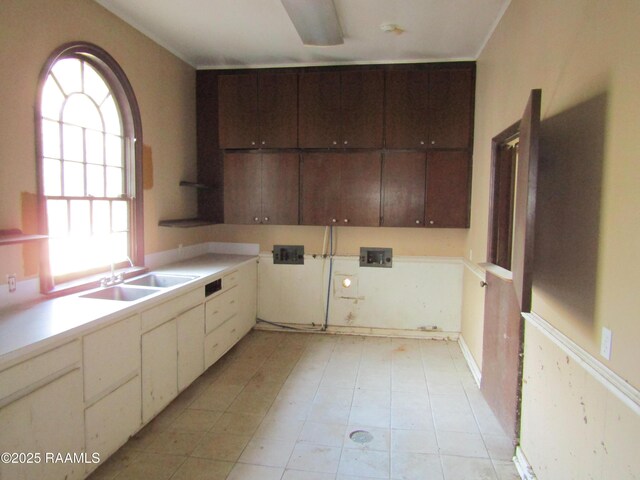 laundry room featuring a sink, washer hookup, light tile patterned floors, and cabinet space