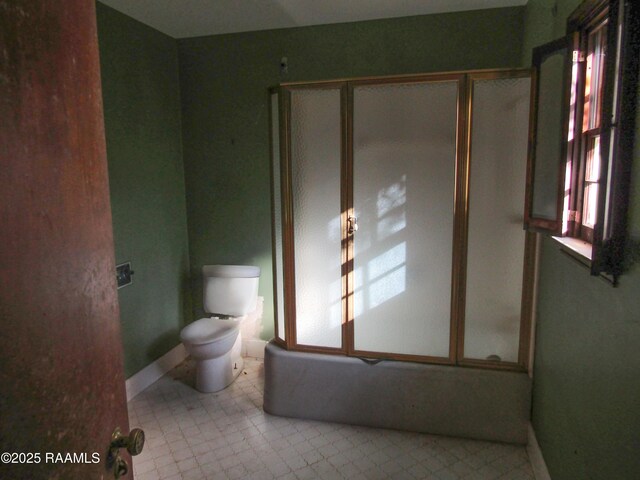 bathroom with toilet and baseboards