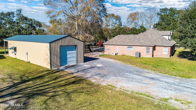 detached garage featuring driveway and cooling unit