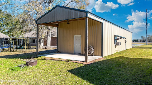 view of outbuilding with an outbuilding, a trampoline, and cooling unit