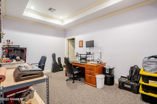 carpeted office space with ornamental molding, a raised ceiling, visible vents, and baseboards