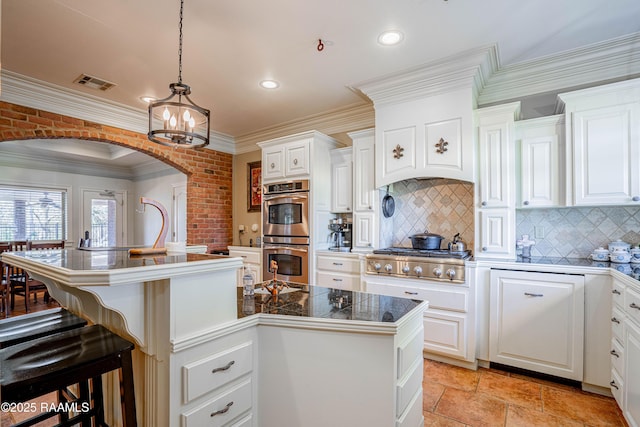 kitchen with visible vents, stainless steel appliances, a center island with sink, and white cabinetry