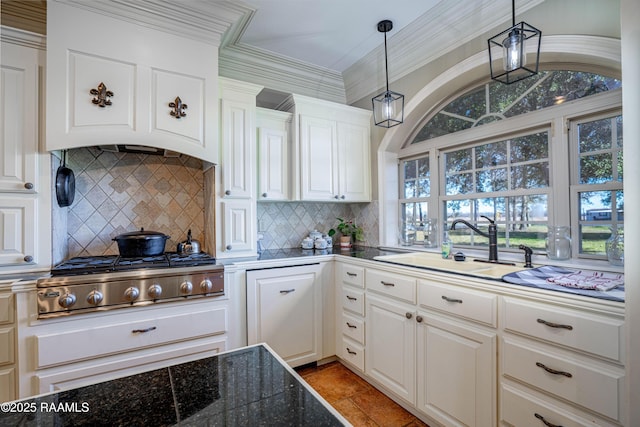 kitchen with tile countertops, stainless steel gas cooktop, a sink, white cabinetry, and ornamental molding