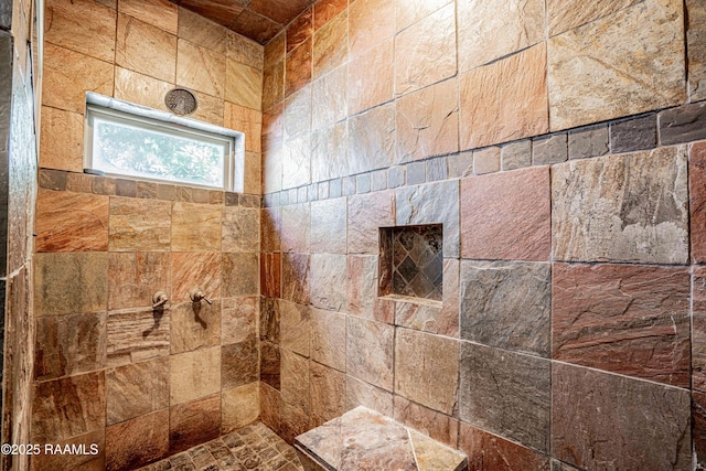 interior details with a tile shower